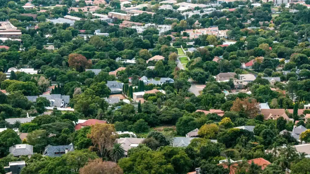 Aerial view of a leafy suburban neighborhood with homes and trees.