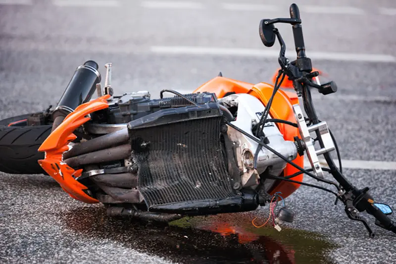 Motorcycle and vehicle involved in a crash on Mulholland Drive near mile marker 4, with first responders securing the scene.