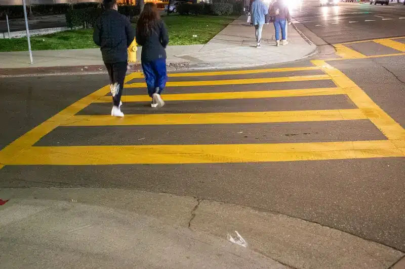 Emergency responders assist a pedestrian struck in a collision at Roscoe Boulevard and Ranchito Avenue in Los Angeles.